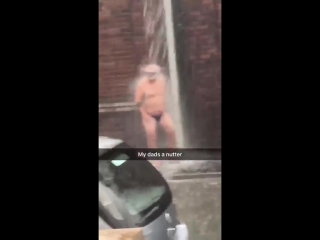 best dad stands under overflowing gutter wearing just swimming trunks and a snorkel best